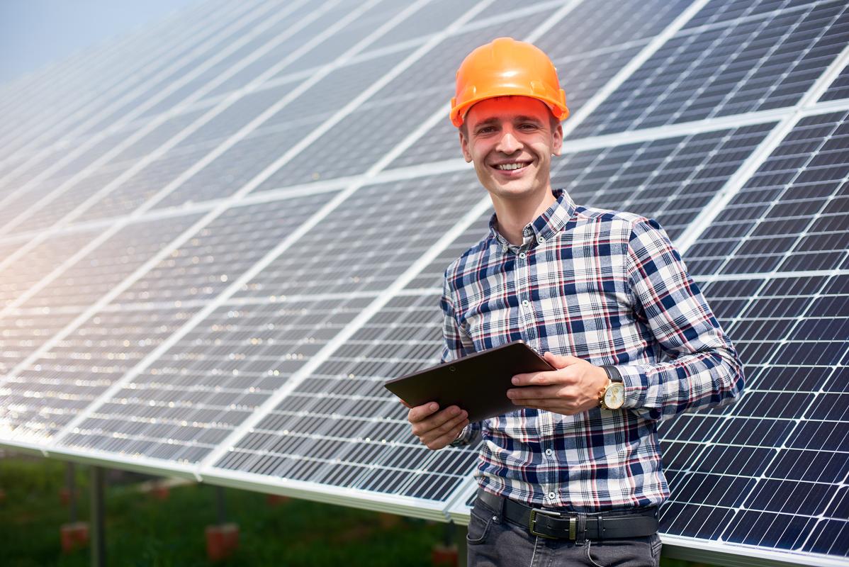 smiling-male-with-tablet-near-the-solar-station-g-2022-05-17-06-03-17-utc (1)